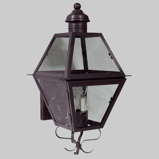 Hexagonal outdoor wall light fixture with glass cover on a gray background