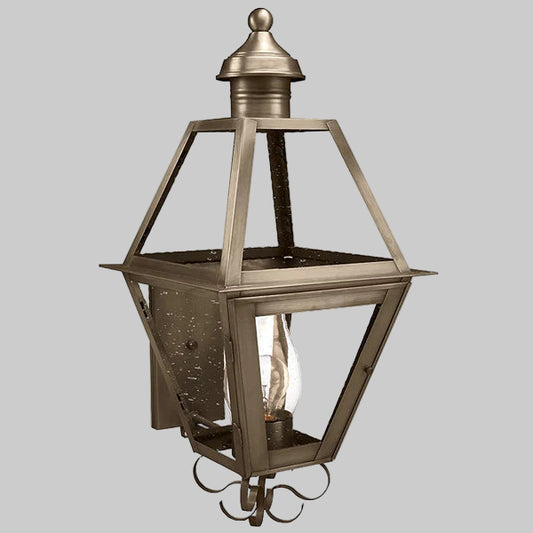 Decorative outdoor lantern with metallic finish on a gray background