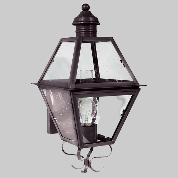 Traditional outdoor wall light fixture with clear glass panels on a gray background