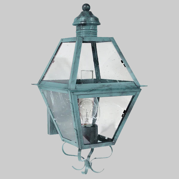 Vintage-style outdoor wall light fixture with clear glass on a gray background