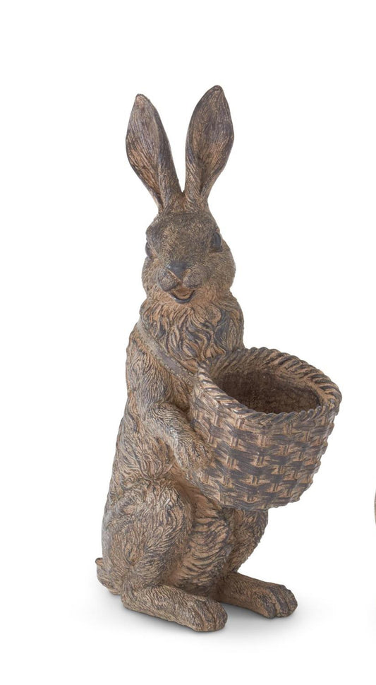 Decorative rabbit statue holding a basket on a white background