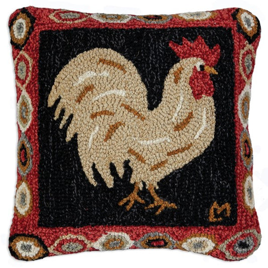 A square-shaped wool pillow with a brown rooster design and a red and black border with floral patterns.