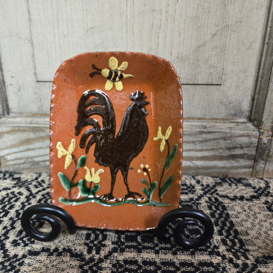 Small rectangular redware plate with a rooster, flower and bee motif