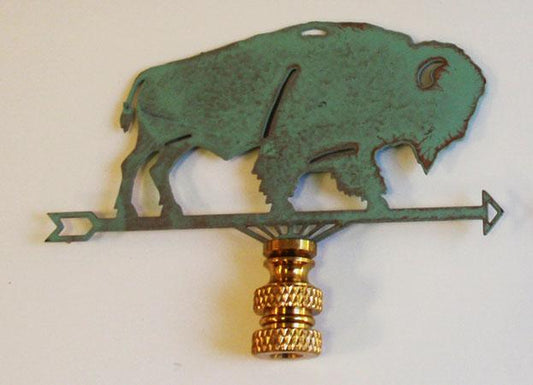 A verdigris lamp finial in the shape of a buffalo, with a green copper body and a gold-colored decorative thread holder.