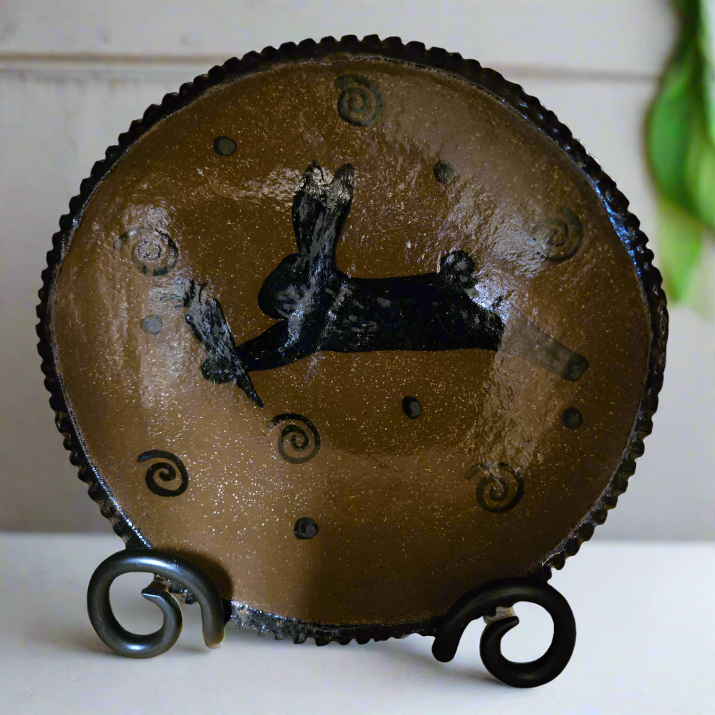 Round stoneware plate with a bunny holding a carrot surrounded by polka dots and squiggles