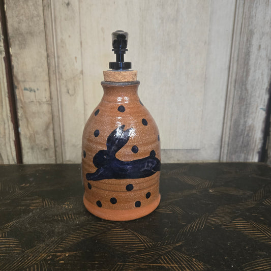 Ceramic bottle with decorative elements on a wooden surface