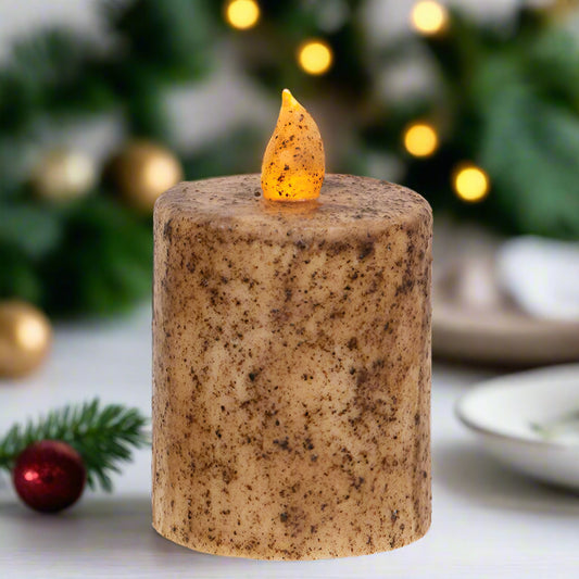 Decorative candle with a flame on a table with festive background
