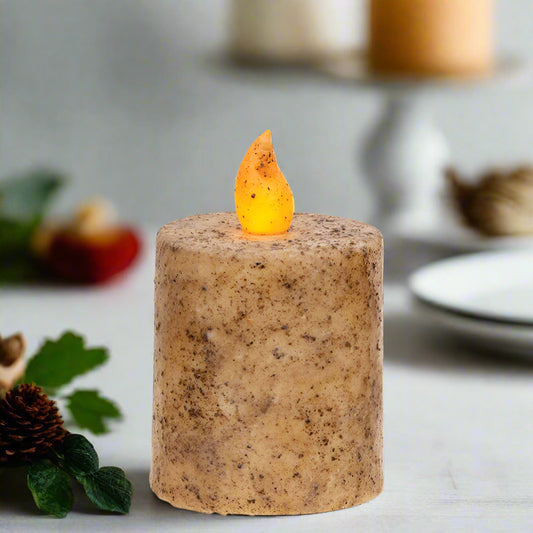Decorative candle with a flame on a white background