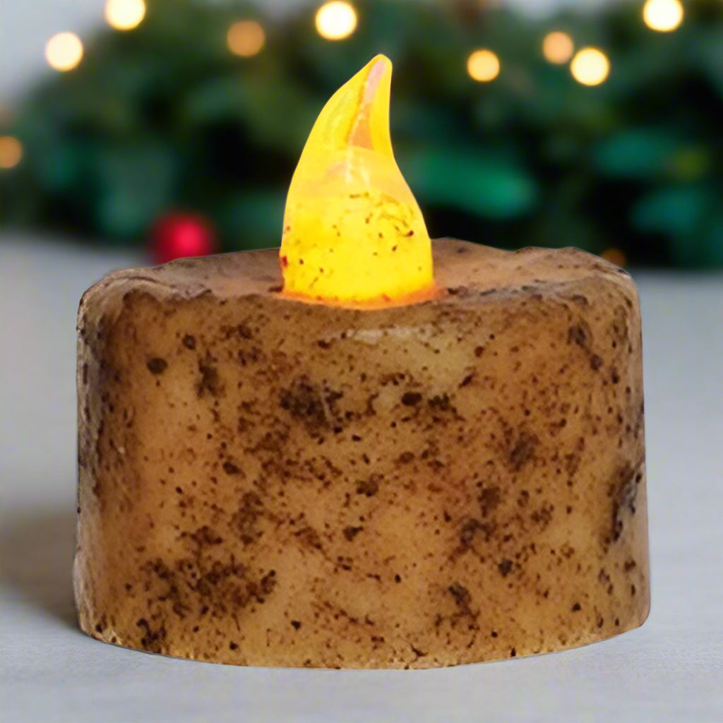Flickering candle light on a textured brown base with a white background