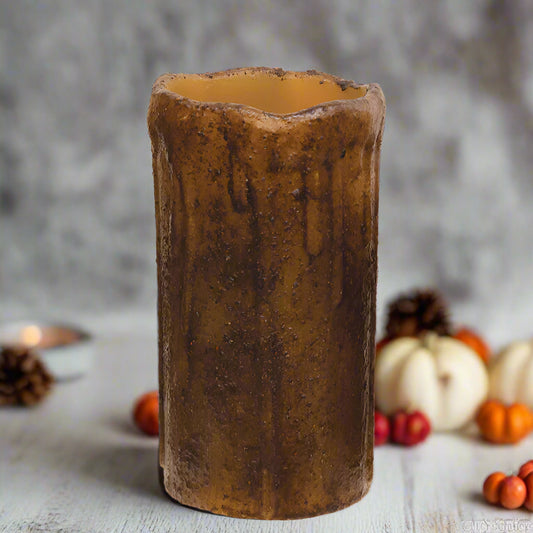 Decorative candle holder with a rustic, tree-trunk-like design on a white background