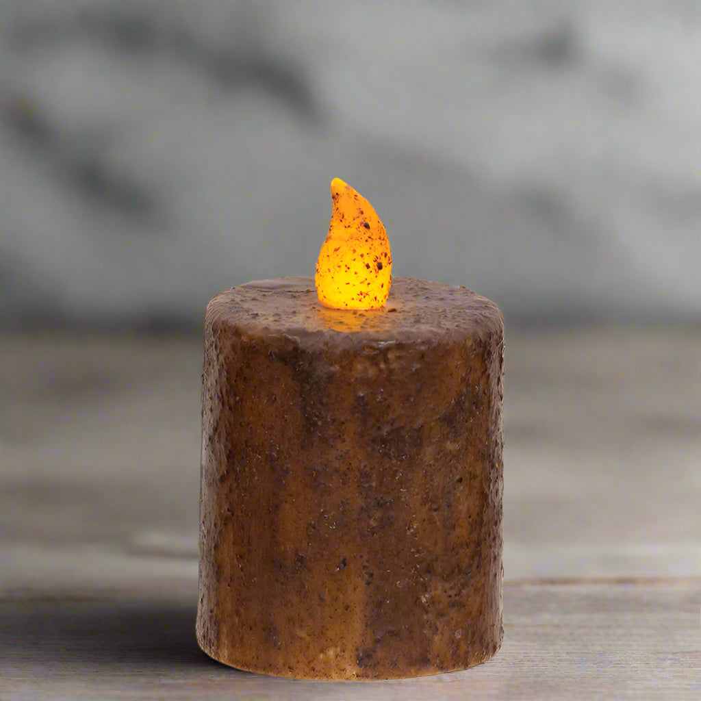 Decorative candle with a flame on a wooden surface