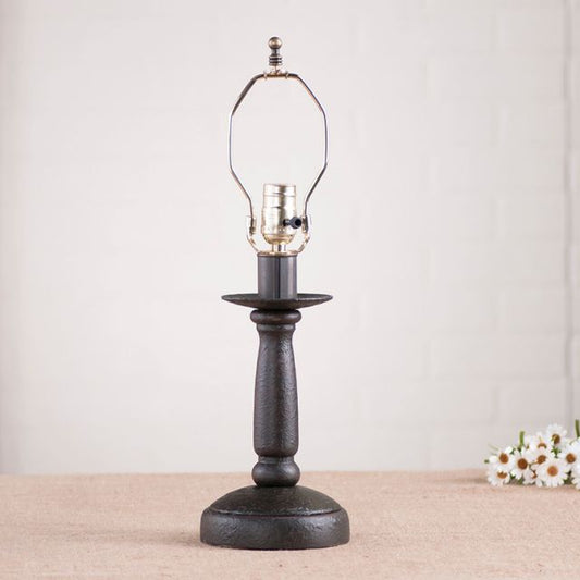 Butcher's Lamp Base in Americana Black on white background with daisies beside it.