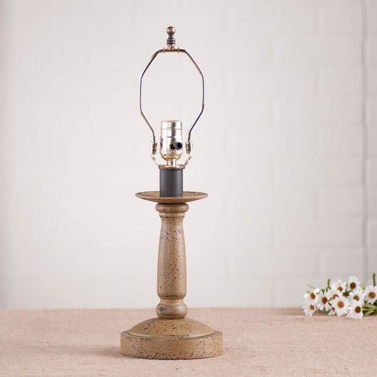 Butcher's Lamp Base in Americana Pearwood with white background and daisies beside it.
