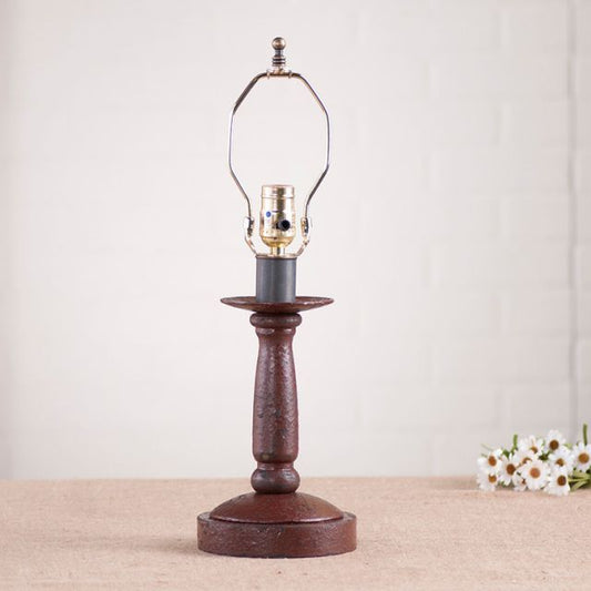 Butcher's Lamp Base in Americana Red on white background with daisies beside it.
