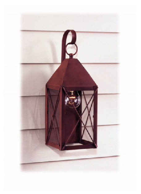 A Venetian Red Byram wall light mounted on a white wall, featuring a traditional lantern design with a visible light bulb inside.