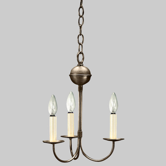 Bronze chandelier with three candle-style lights on a white background
