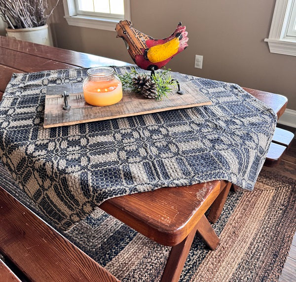 Black and tan table square on table with centerpiece.