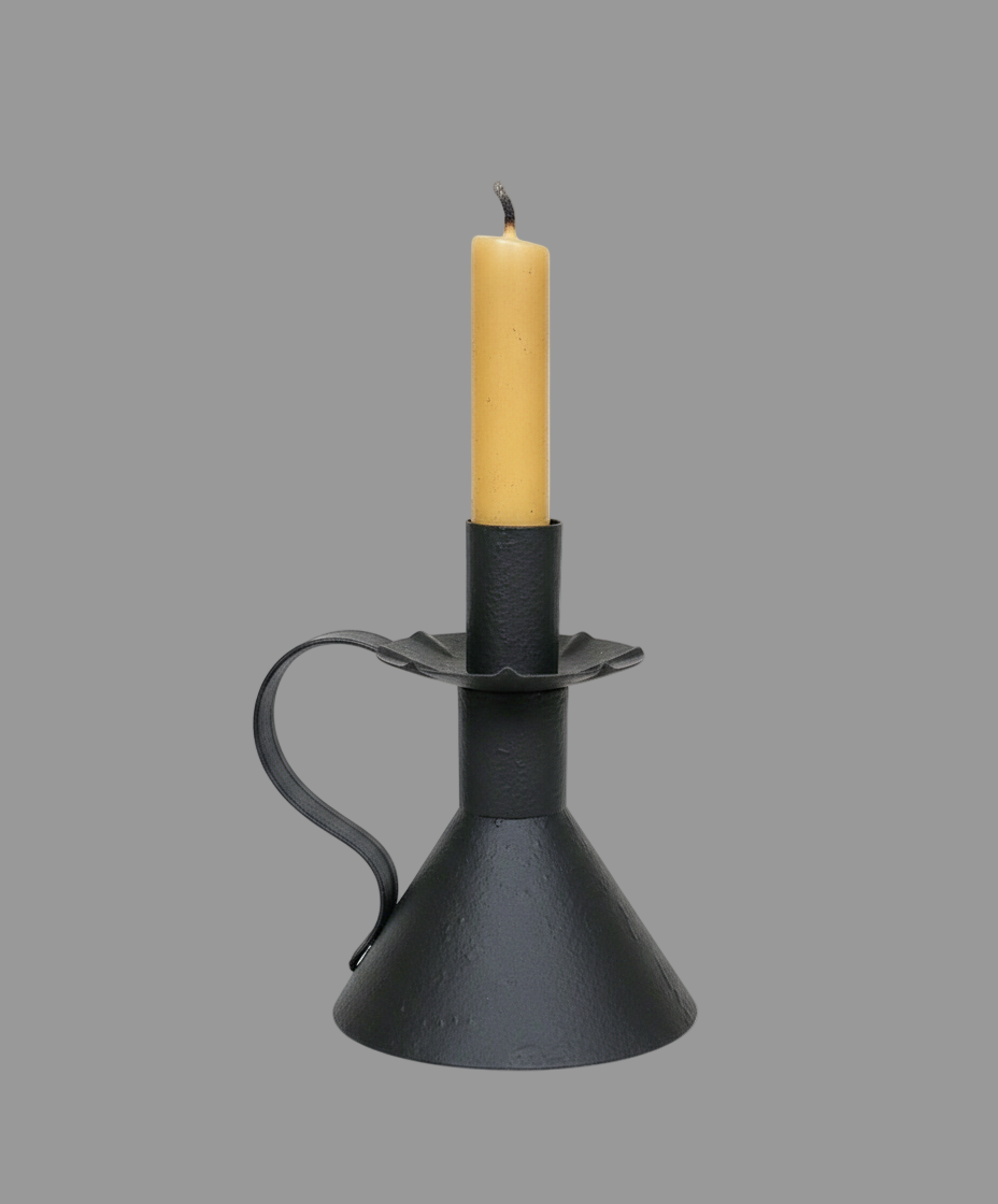Black candle holder with a yellow candle on a white background