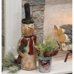 Snowman doll with black top hat holding a candy cane