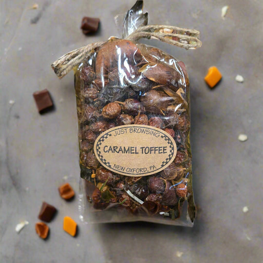 Caramel toffee product with a label on a green leafy background