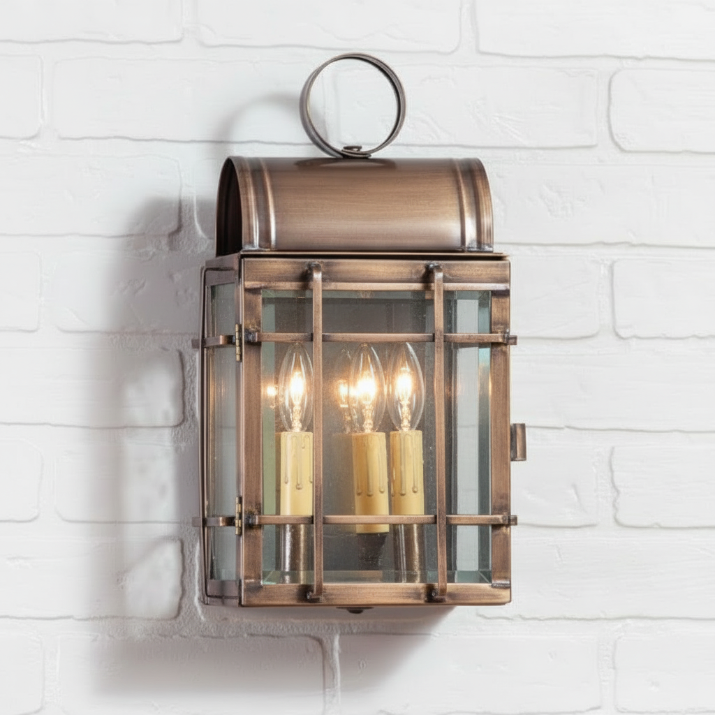 Bronze wall-mounted lantern with glass panels on a white brick wall background