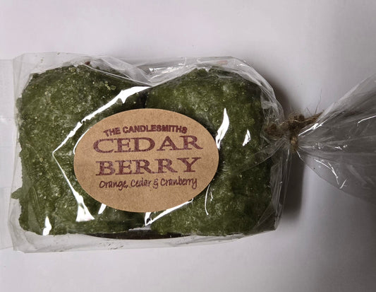 A pack of two green candles tied with a label that reads 'The Candlesmiths Cedar Berry'.