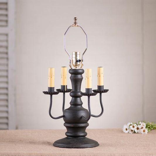 Decorative table lamp with candle-style lights on a neutral background