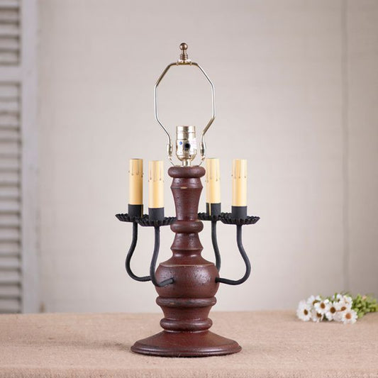 Wooden candelabra lamp with four candle holders on a neutral background