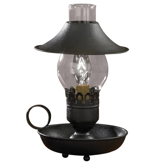 A black chamberstick lamp with an adjustable shade and a metal base, featuring a clear glass chimney and a bronze-colored lamp base.