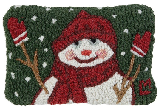 Rectangular green pillow with a snowman in red hat, scarf, and mittens