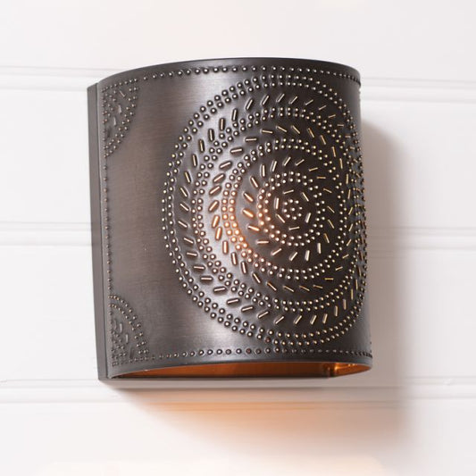 Decorative wall sconce with intricate metalwork on a white background