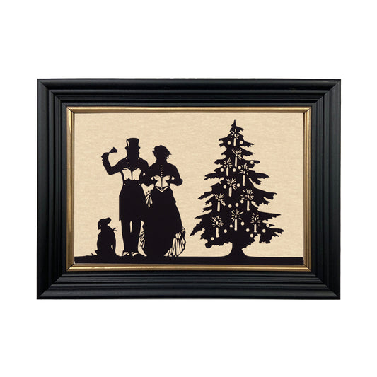 A black, solid ash wood frame with gold trim, featuring a paper cut silhouette of an early American couple singing carols next to a Christmas tree.