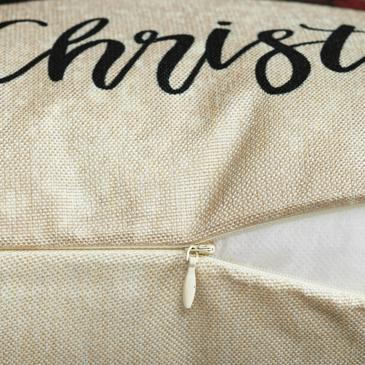 Close-up of the Christmas pillow cover’s open zipper, cream woven fabric, black script lettering, and white pillow insert inside.