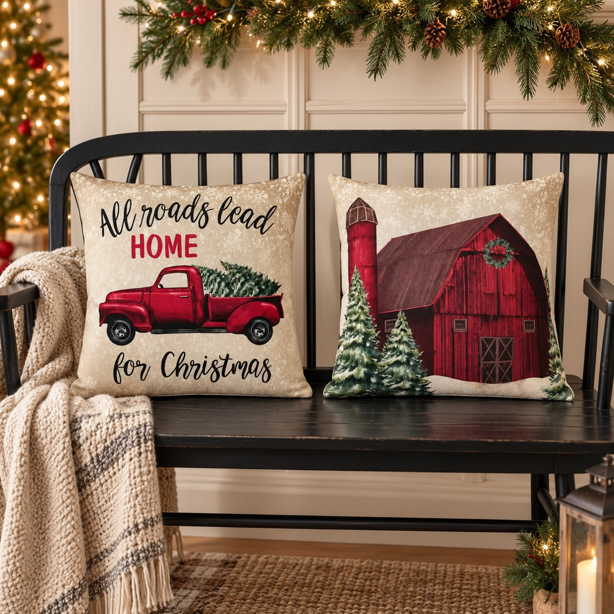 Christmas Farm pillow cover pair featuring a red truck and snowy red barn, styled on a black bench beneath Christmas greenery.