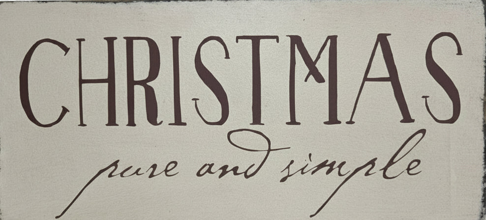 Decorative sign with 'Christmas pure and simple' text on a wooden background