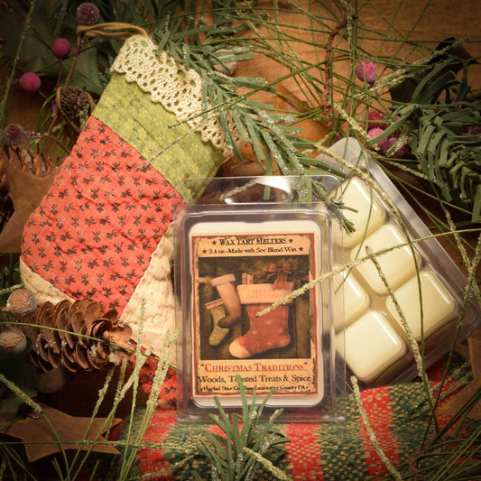 Mini pack of 6 Christmas-scented wax tarts in a clear plastic clamshell packet, displayed beside holiday-themed decorations.