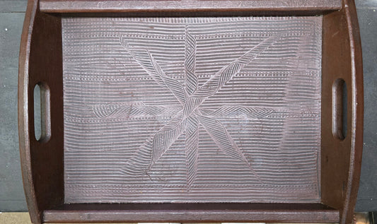 Decorative wood tray with star pattern on a wood floor