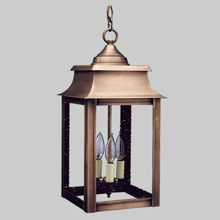 Bronze outdoor lantern with three candle-like lights on a white background