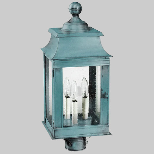 Teal outdoor lantern with clear glass on a white background