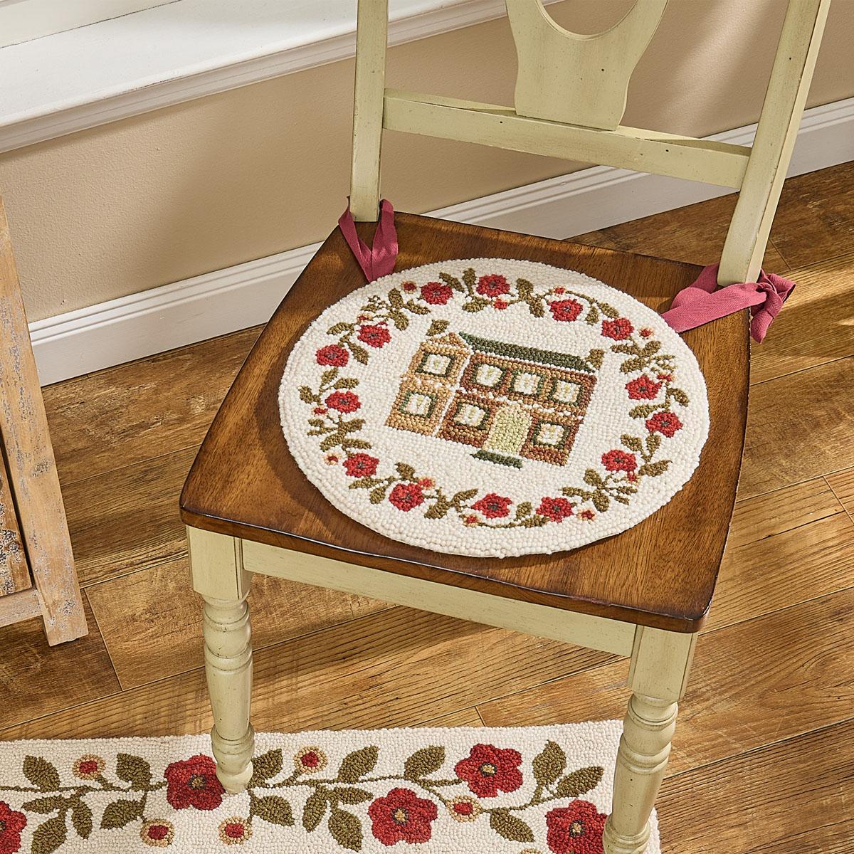 Decorative round mat with a house design on a wooden chair