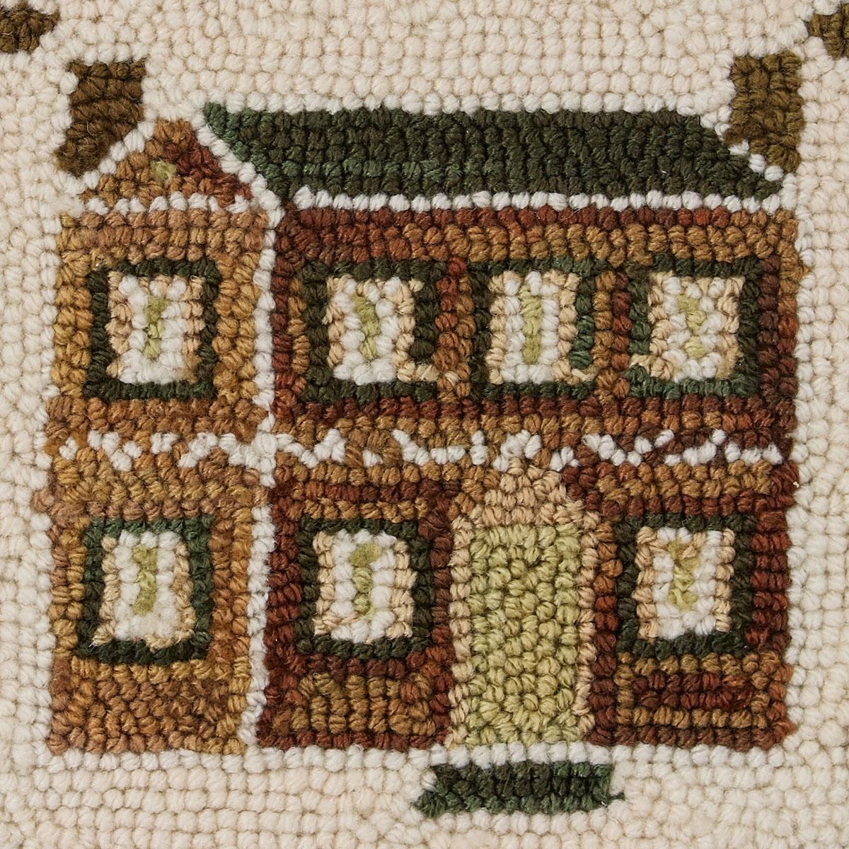 Textured fabric pattern with a house design in brown, green, and beige colors.