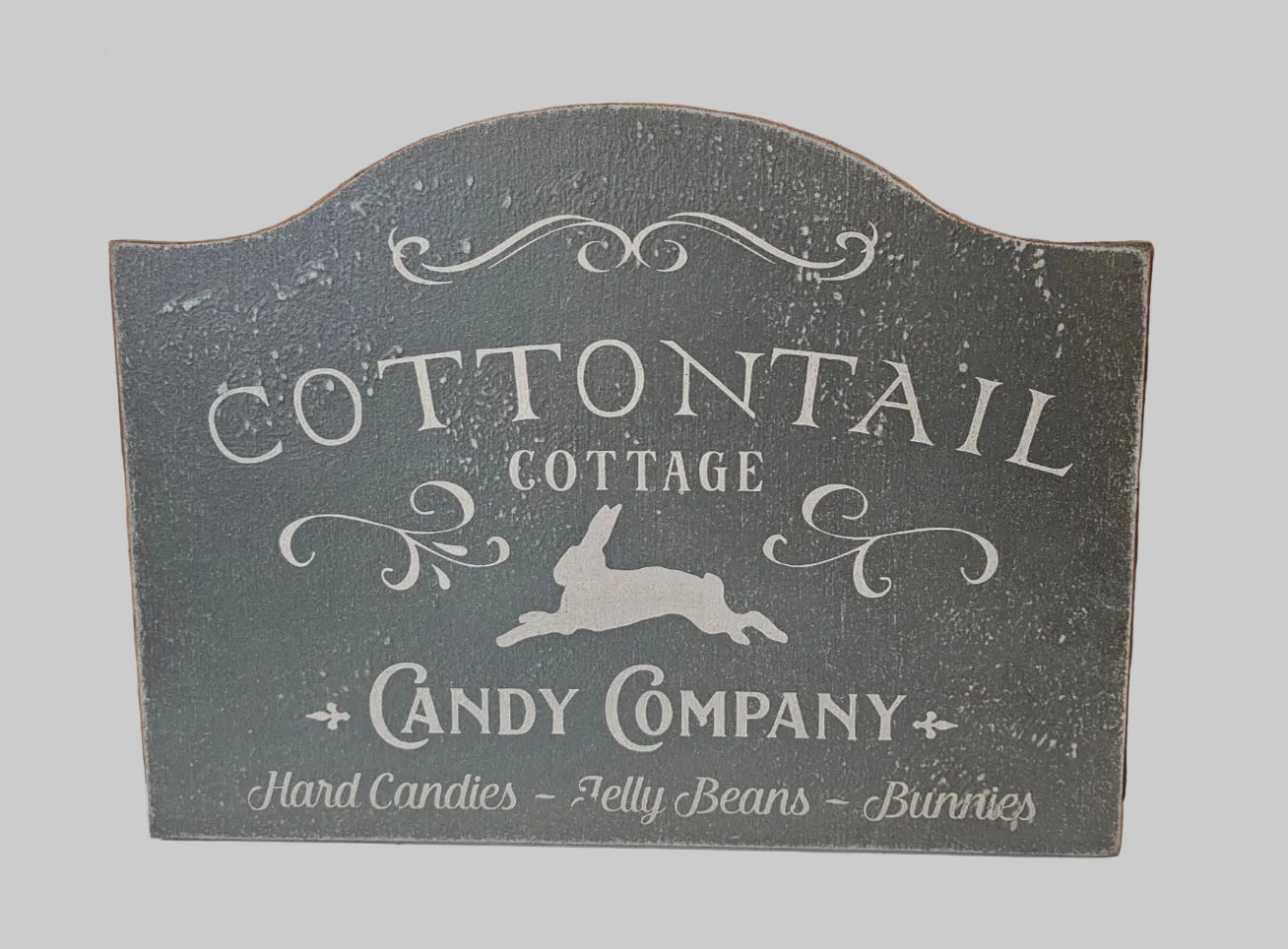 Decorative sign for Cottontail Cottage Candy Company with rabbit illustration on a gray background