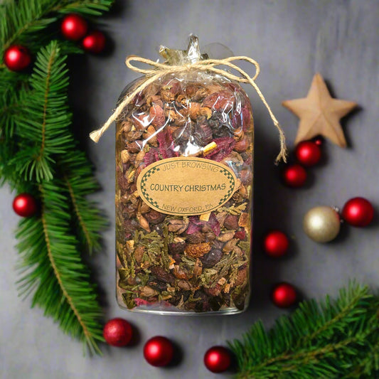 Bag of 'Country Christmas' potpourri with festive decorations on a gray background
