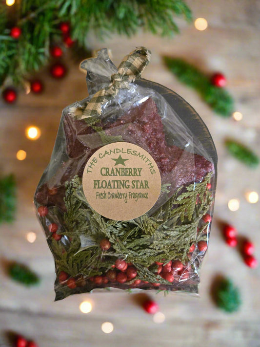 Cranberry floating star fragrance packet with Christmas decorations in the background