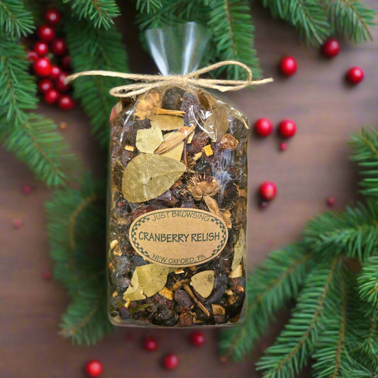 Packaged cranberry relish with Christmas decorations on a wooden surface