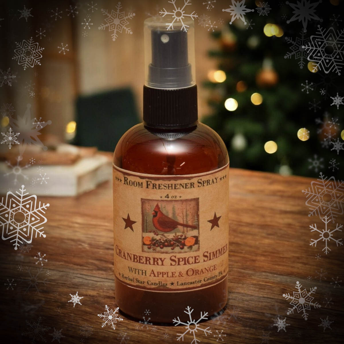 Room freshener spray bottle labeled 'Cranberry Spice Simmer' on a wooden surface with Christmas decorations in the background.