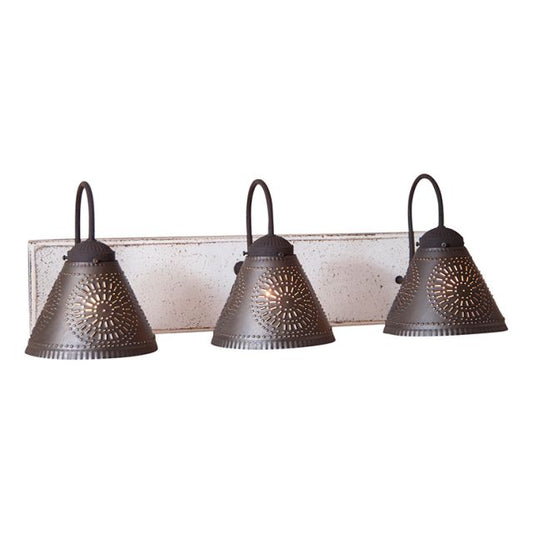 A vintage white three-light crestwood vanity light with black textured arms and crimped pans, handcrafted with a distressed painted finish.