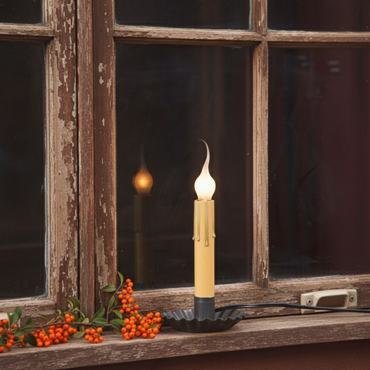 Candle on a windowsill with a rustic window and dark background
