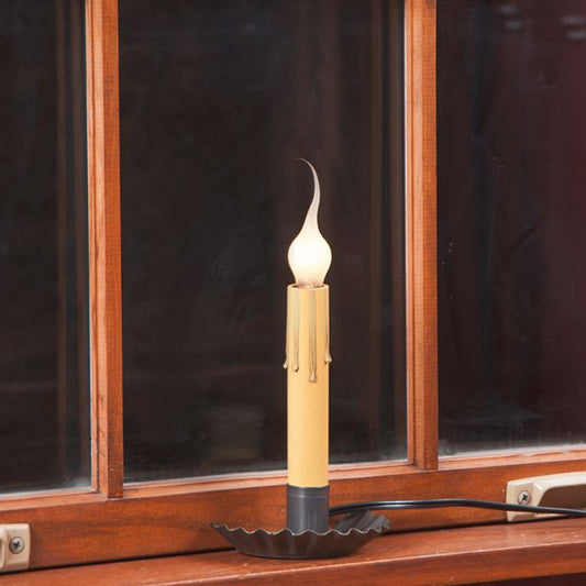 Crimped tin window light in country tin finish sitting on a window sill.