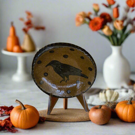Small round stoneware plate with crow and polka dot motif